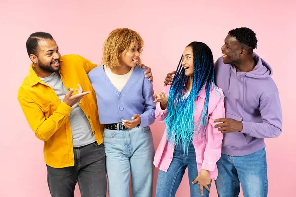 stock image Portrait of attractive smiling African American friends wearing stylish casual outfit communication, talking isolated on pink background. Friendship 