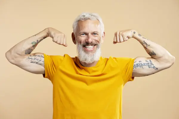 Portrait Smiling Mature Man Wearing Casual Yellow Shirt Showing Biceps — Stock Photo, Image