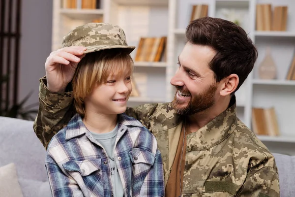 Smiling Son Wearing His Father Army Hat Sits His Dad — Stock Photo, Image