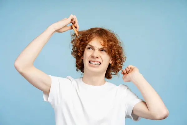 Sad Curly Haired Ginger Boy Holding Damaged Curly Hair Looking — Stock Photo, Image