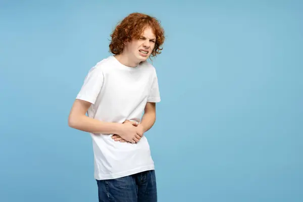 Unhappy Red Haired Boy Having Stomach Ache Isolated Blue Background — Stock Photo, Image
