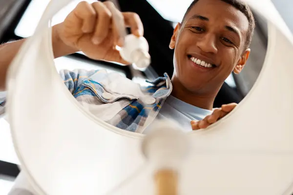 Portrait Smiling Young African American Man Master Replacing Light Bulb — Stock Photo, Image