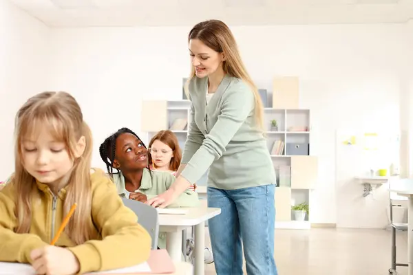 Smiling Female Teacher Standing African American Boy While Helping Her — Stock Photo, Image