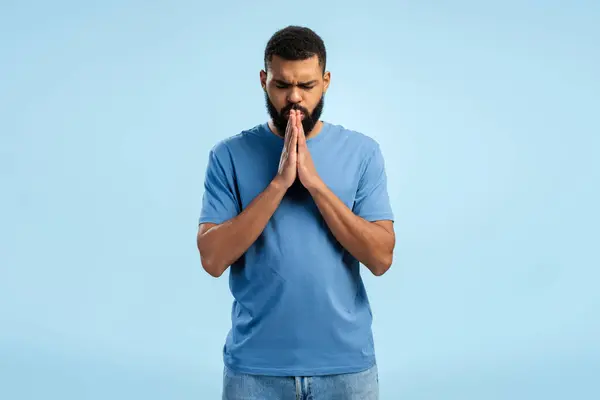 Young African American Bearded Man Shirt Showing Pray Gesture While — Stock Photo, Image