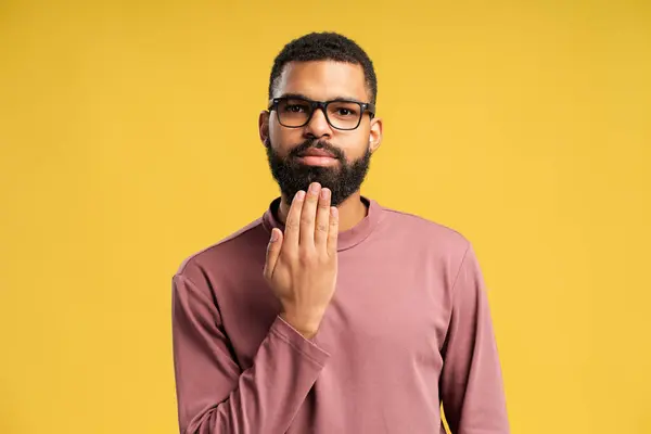 stock image Young African American man showing word INTERPRETER in sign language, looking at camera, isolated on yellow background. People lifestyle concept