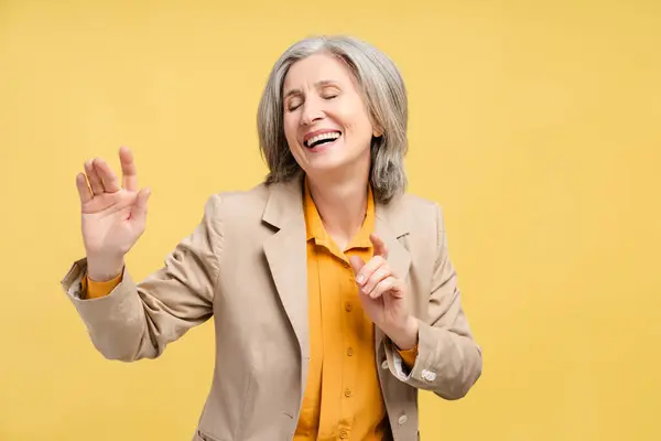 Portrait Excited Senior Businesswoman Formal Suit Dancing Rejoicing Isolated Yellow Royalty Free Stock Photos