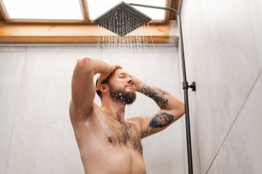 Beyaz, yakışıklı, sakallı seksi adamın portresi. Duş alıyor, başını yıkıyor, gözlerini kapıyor. Çıplaklık, cinsellik kavramı