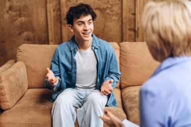 Ofiste genç bir çocukla çalışan kadın psikoloğun portresi. Psikolojik destek kavramı