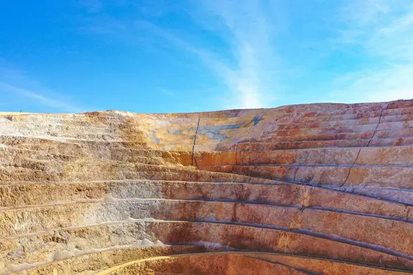 stock image Open pit mine in full operation, with machinery extracting minerals.