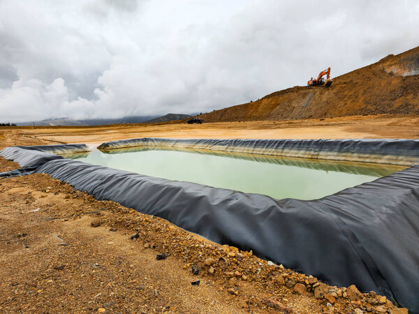 Construction of geomembrane pool in open pit mine.