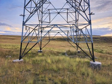Concrete foundations for supporting high-voltage towers in high Andean meadows clipart