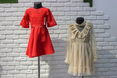 Red and beige dress on mannequin in store