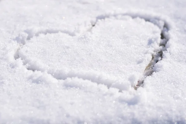 Heart outlined on snow, symbol of love