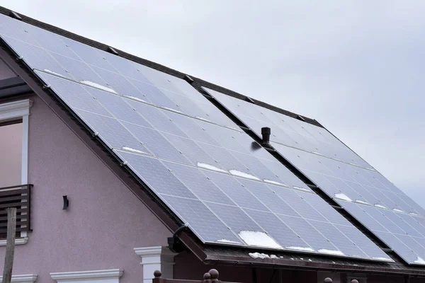 House roof with solar panels, alternative energy