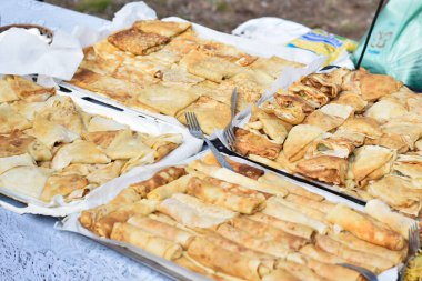 Pancakes with filling on tray outdoors at pancake festival, street food