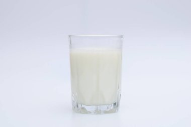 Beyaz arka planda bir bardak taze süt