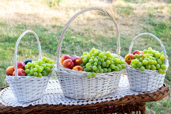 White Baskets Full Fruits Grapes Apples Plums Table Grass — Stock Photo, Image