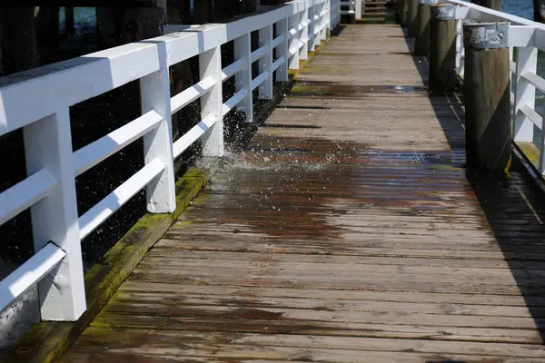 Tahta bir köprünün üzerinden su damlaları