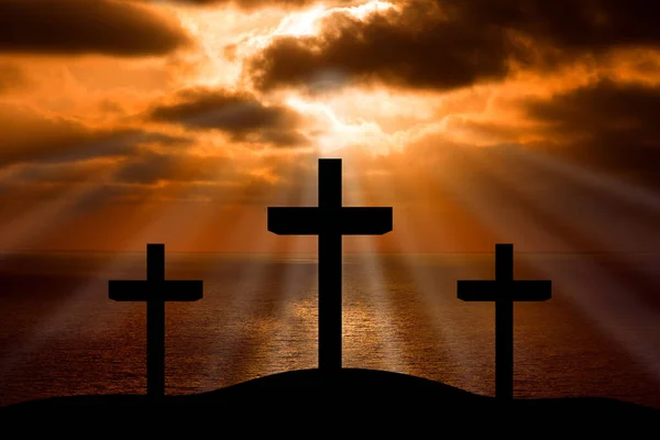Silhouette of Jesus Christ crucifixion on cross on Good Friday Easter over heaven sunset sunrise -Three Crosses On Hill landscape horizontal