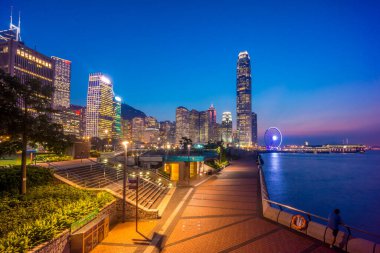 Night scenery of skyline/cityscape across Admiralty, Central, Victoria harbor, Hong Kong Island business district, with Ferris Wheel