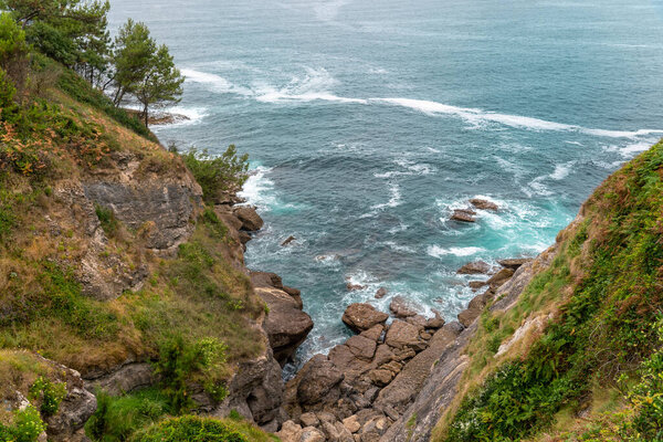 Spectacular landscape in Cantabria - Spain. High cliffs, with green vegetation. Atlantic Ocean with spectacular water colours. Virgin and Natural landscape.