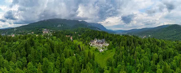 stock image Aerial perspective of spectacular Peles Castle situated in Sinaia, Romania. Neo-Renaissance castle in the Carpathian Mountains surrounded by forest. Constructed for King Carol I. Travel destination. 