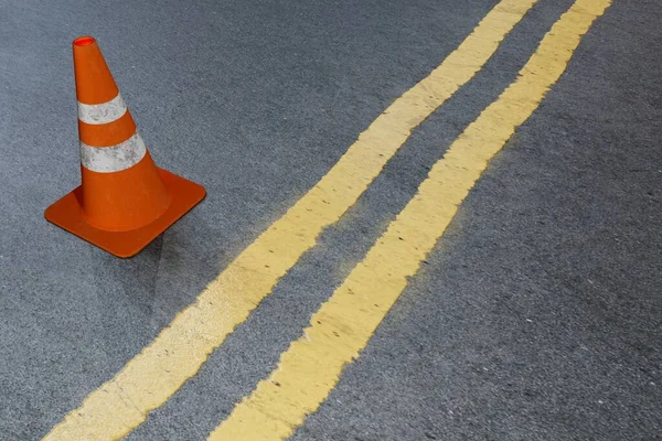 restriction on the road. markings and a road cone on a gray background. 3D render.