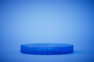 a round podium to place products or blue text on a blue background. 3D render.