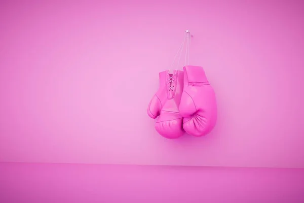 Hanging pink boxing gloves isolated on pastel background. 3d render.