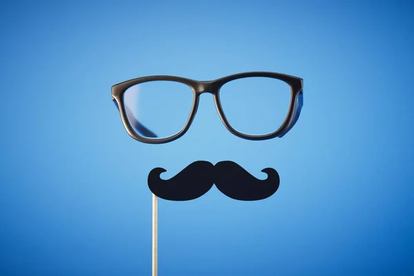 stock image fake mustache and glasses on a blue background. 3D render.