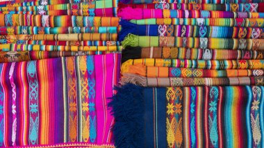 Otavalo, Imbabura / Ekvador - 14 Ekim 2023: Yerli dokusuna sahip çok renkli çizgiler ve çizgiler tasarlanmış kumaşların ayrıntıları