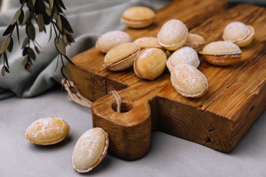 Walnut shaped cookies with caramel on wood