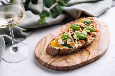 bruschetta with pesto, hazelnuts, cheese and basil