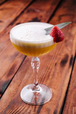 sweet alcoholic orange cocktail with foam