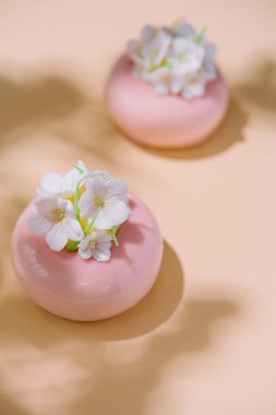 Pink mousse cakes decorated with white flowers