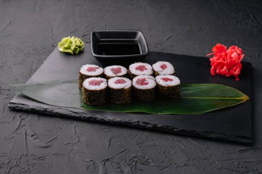 Maki rolls with tuna on black stone