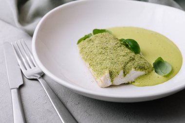 fried fish with basil sauce on plate