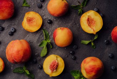 Fresh ripe peaches with blueberries top view