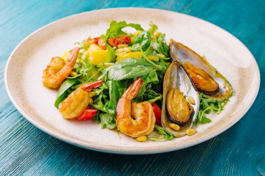 salad with shrimp and mussels on plate