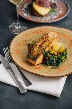 Roasted salmon with wakame seaweed on plate