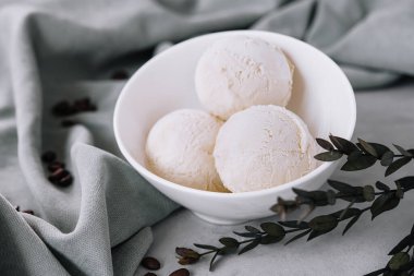 Vanilla ice cream balls on white bowl
