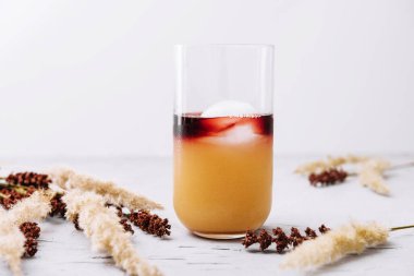 Glass of tasty coffee with orange juice