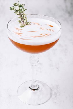 Sweet and fresh cold alcoholic orange cocktail with foam