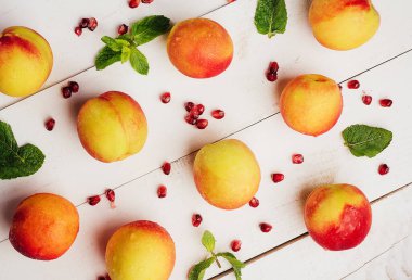ripe apricots with fresh pomegranate seeds