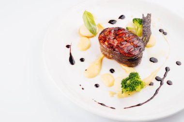 Grilled fish with mashed potatoes on plate