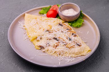 pancakes with mushrooms and parmesan on plate