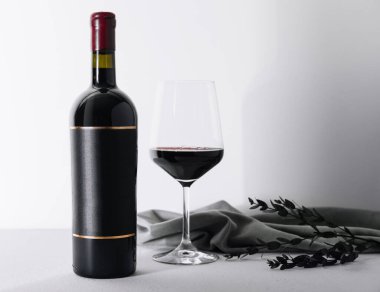 Red wine and wine bottle on stone