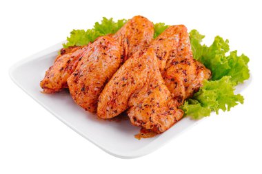 pile of marinated chicken wings on plate