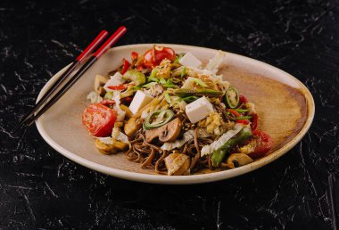 buckwheat noodles with grilled vegetables on plate