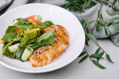 grapefruit and turkey breast salad in white plate